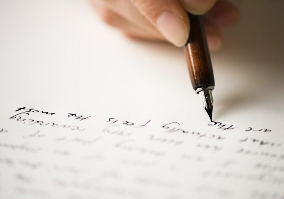 Writing letter to a friend. Selective focus and shallow depth of field.